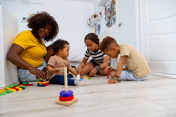 istock Mother and children playing with building blocks at home 2208476113