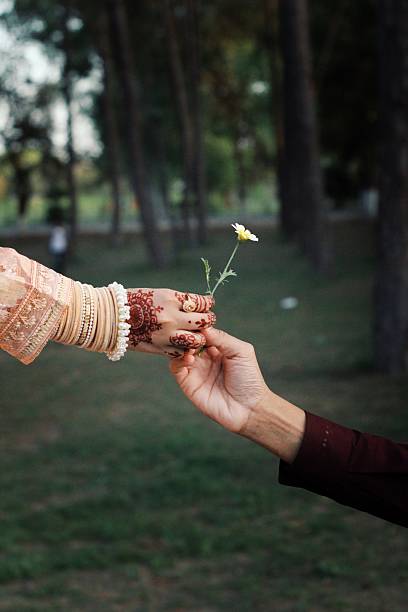FLOWER IN COUPLE HAND in a park .A symbol of love and romance