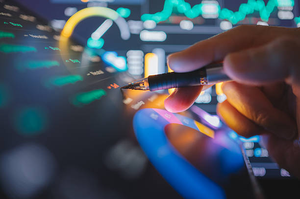 istock hand analyzing volatile market trends on digital tablet with financial charts and ai analytics 2026 2208485129