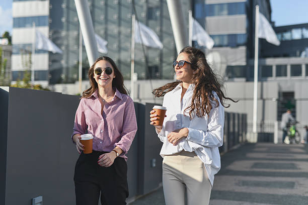 istock Female Students Laughing While Running Towards University Being Late 2208486324