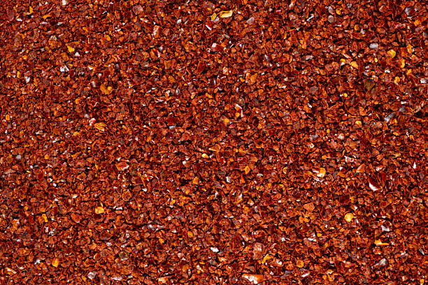istock Deep red chili pepper powder close-up texture top view 2208488764