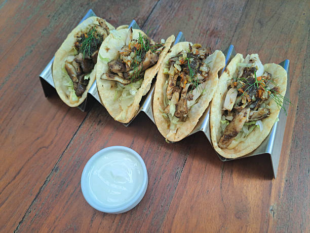 istock Yummy Red Curry Chicken Taco With Pan Seared Chicken Leg, Red Curry Sauce, Iceberg Lettuce, Aioli, Taco Shell Yoghurt, Sauteed Brunoise Potato And Carrot. Mediterranean Food Menu. 2208488768