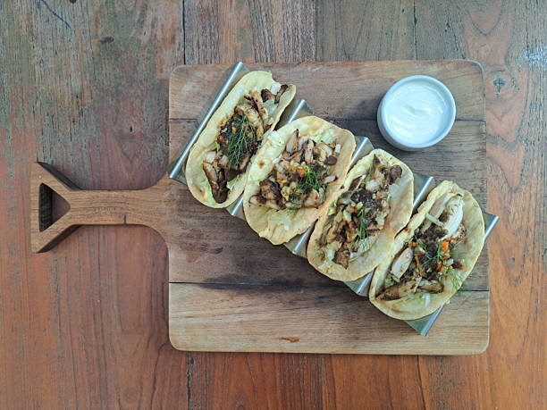Red Curry Chicken Taco With Pan Seared Chicken Leg, Red Curry Sauce, Iceberg Lettuce, Aioli, Taco Shell Yoghurt,  Sauteed Brunoise Potato And Carrot. Mediterranean Food Menu. Top View.