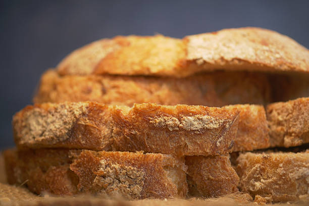 istock Freshly Sliced Whole Grain Bread Arranged Neatly on Wooden Surface 2208489437