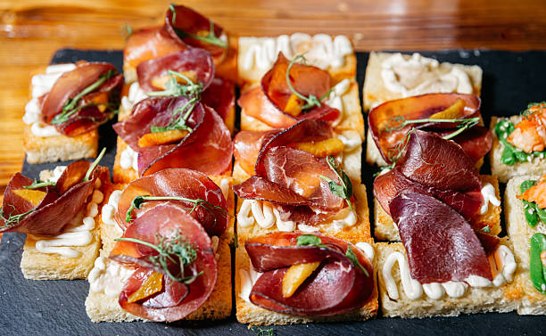 Gourmet bruschetta with cured meat and cream on bread.