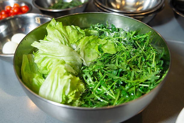 istock Fresh Washed Lettuce and Arugula in Bowl. 2208491048