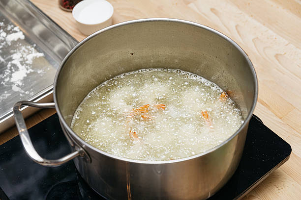 istock Deep Frying Shrimp in Hot Cooking Oil. 2208491490
