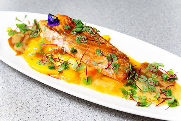 istock Salmon fillet with mango sauce and microgreens. 2208491522