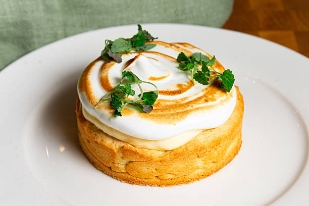 istock Lemon tart with toasted meringue and herbs. 2208491540