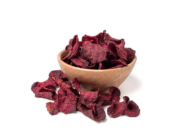 Dry beetroot chips isolated, dried sliced red beet flakes pile, beet root pieces and chips
