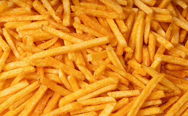 istock Fried chips sticks texture background, finger potato ketchup flavored chips pattern, shoestring fries 2208492260