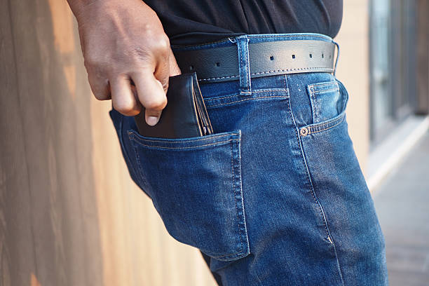 istock A Man is Reaching for His Wallet That is Inside His Jeans Pocket 2208493524