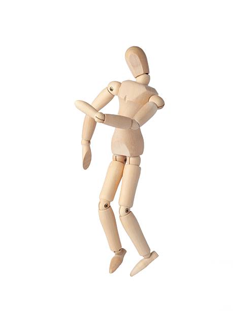 A Wooden dummy stands tall, perfectly balanced like a Poseable figure. This Articulated mannequin and Wooden model captures a stable pose, ideal for artists and creating dynamic sketches.