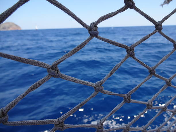 A mesh of material that is a decoration on a boat, performing protective functions. Texture or background. Seascape.