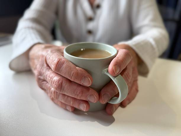 istock Woman holding a cup of coffee 2208498584