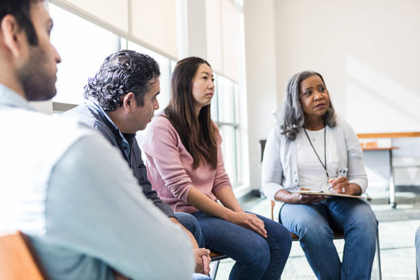 istock Group therapy session: Diverse adults discussing mental health 2208499749