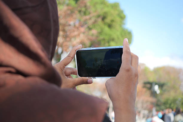 istock Capturing Moments: A Person Taking Photos Outdoors with Smartphone 2208501880