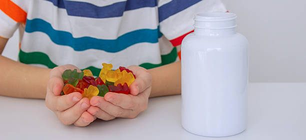 istock The boy eats jelly beans or takes vitamins 2208503725