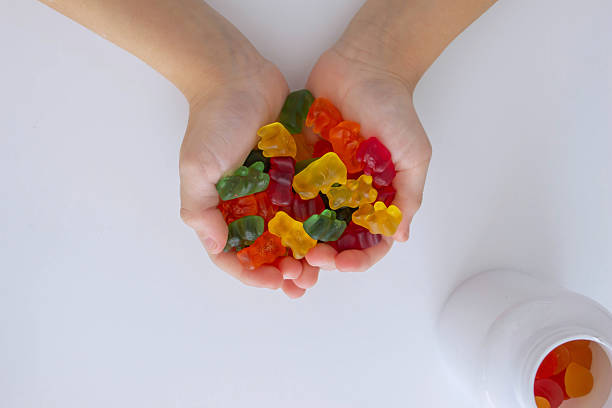 istock The boy eats jelly beans or takes vitamins 2208503729