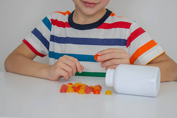istock The boy eats jelly beans or takes vitamins 2208503751