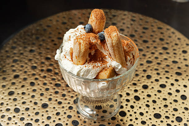 Single Tiramisu Dessert in Glass Cup with Blueberries.