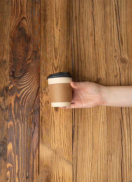 istock Hand Holds Cup, Empty Paper Cup in Hands, Coffee Mug, Teacup, Hot Beverage Mockup, Cup in Arms 2208508987