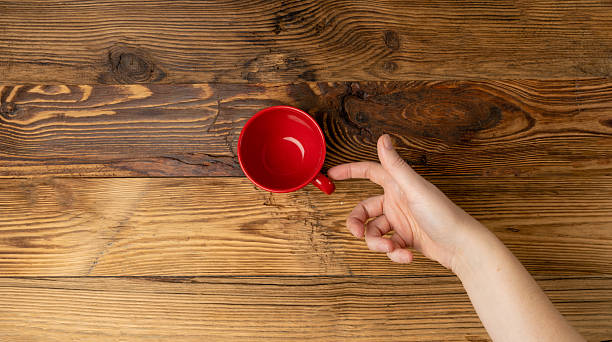 istock Hand Holds Cup, Empty Red Cup in Hands, Coffee Mug, Teacup, Hot Beverage Mockup 2208508989