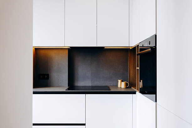 Experience a Modern Minimalist Kitchen that Features a Sleek Design and Inviting Warm Lighting