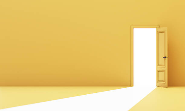 istock Yellow room with single open door letting in a strong white light beam, creating contrast of inner reflection and outward vision. 3d rendering. 2208511310