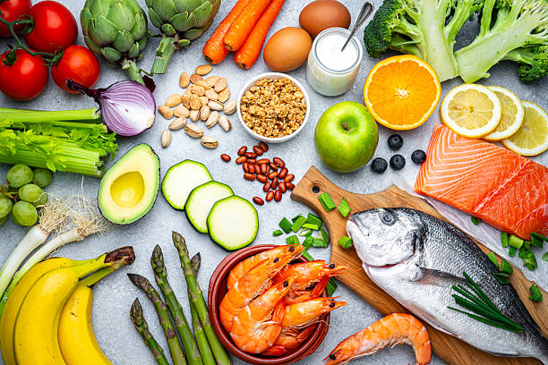 Pescatarian diet: overhead background of plant based food that includes seafood, dairy and eggs