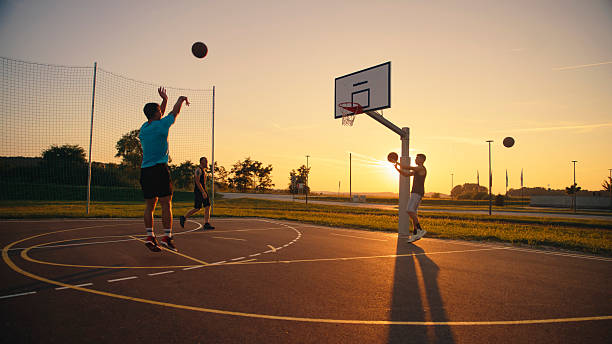 istock Friends Playing Basketball at Sunset 2208512965