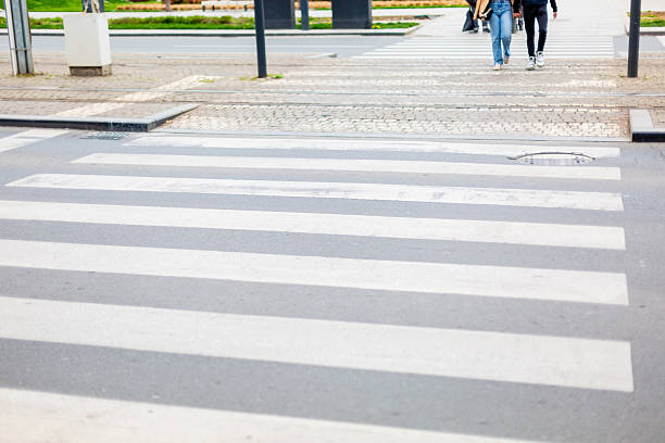 istock Young couple crossing a zebra crossing 2208514055