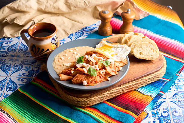 istock Mexican traditional chilaquiles breakfast red salsa 2208514098