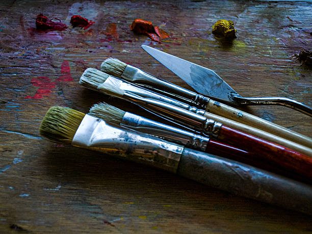 istock Old brushes and oil paints on the palette 2208514213