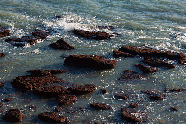 istock Sea waves crashing on rocks in the ocean 2208514565