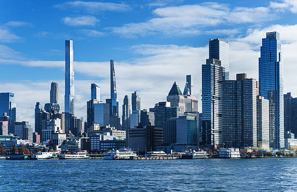 istock Manhattan Skyline Under Blue Sky With Iconic Skyscrapers and Waterfront View 2208515409