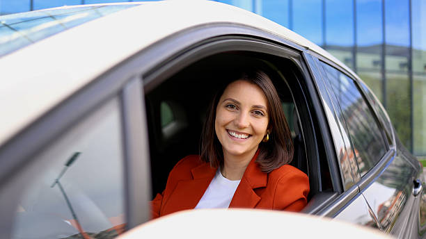 istock Young businesswoman smiling while sitting in car 2208519444