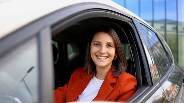 istock Young businesswoman smiling while sitting in her car 2208519505