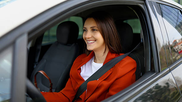 istock Young businesswoman smiling and driving modern car 2208519660