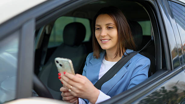istock Businesswoman using smartphone while sitting in car 2208519832