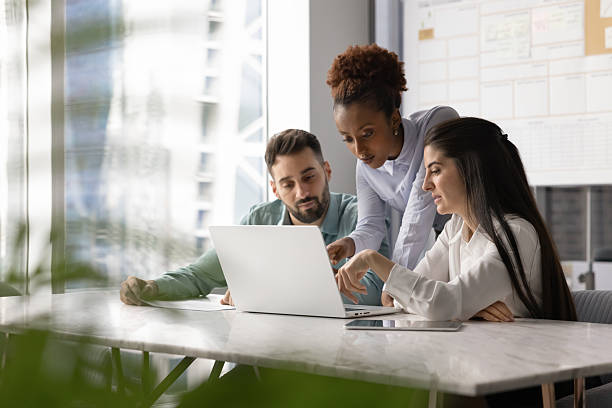 istock Multiethnic group of office colleagues discussing Internet marketing strategy 2208521424