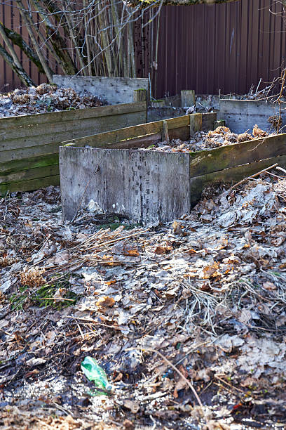istock two large wooden leaf composters stand outside 2208522591
