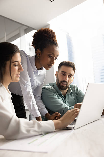 istock Multiethnic team of focused managers working on Internet project together 2208523885