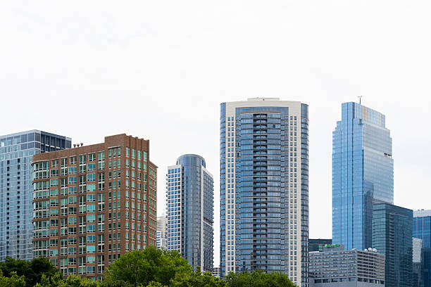 Tall office buildings along the Chicago River in the Central District. Modern skyscrapers. Cloudy blue sky.