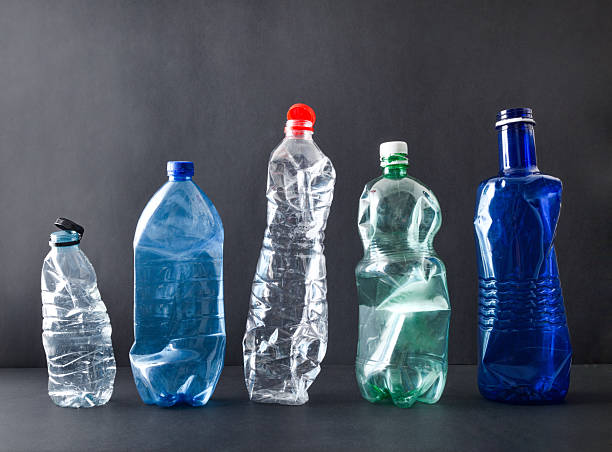 istock Row of plastic bottles isolated on a black background 2208528043