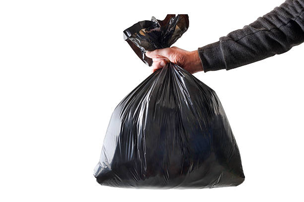 Hand with garbage bag and white isolated background stock photo