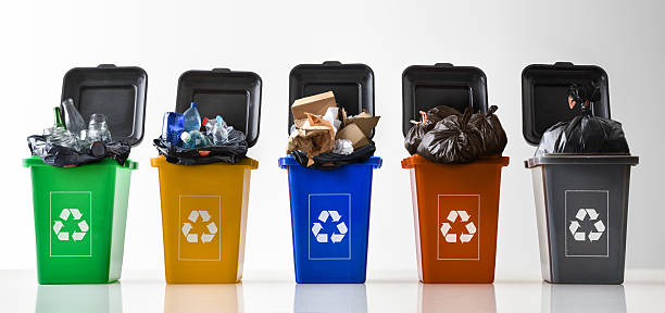 istock Multi-colored recycling bins overflowing with waste and symbol isolated background 2208528059