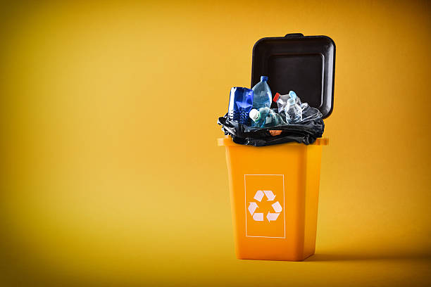 istock Yellow recycling container full of plasticos and  packaging isolated yellow 2208528061