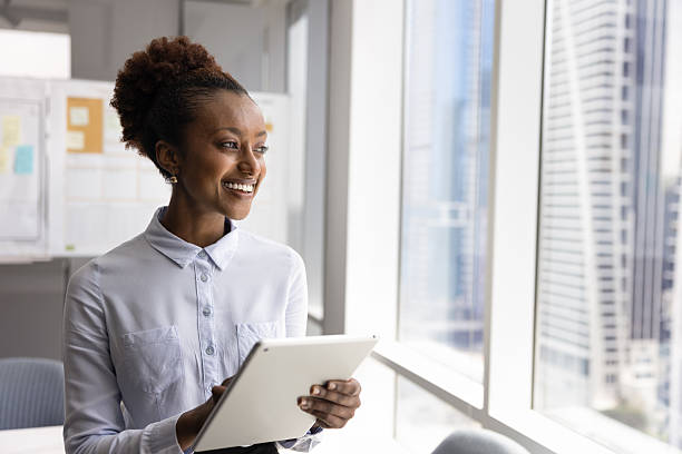 istock Happy young African business executive woman using digital tablet 2208528072
