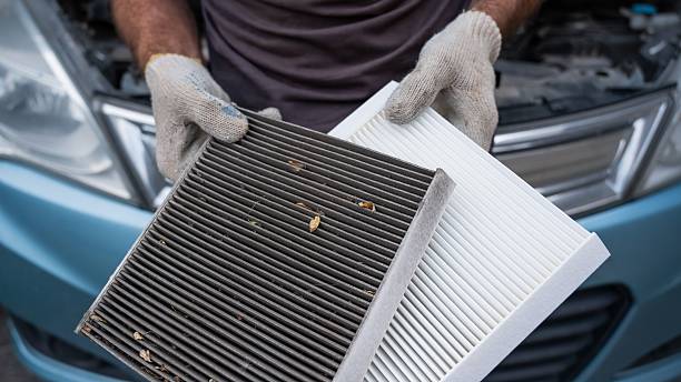 istock The master changes the cabin air filter of the car. 2208529388